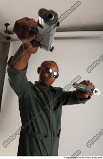 ERIC STANDING POSE WITH GUNS